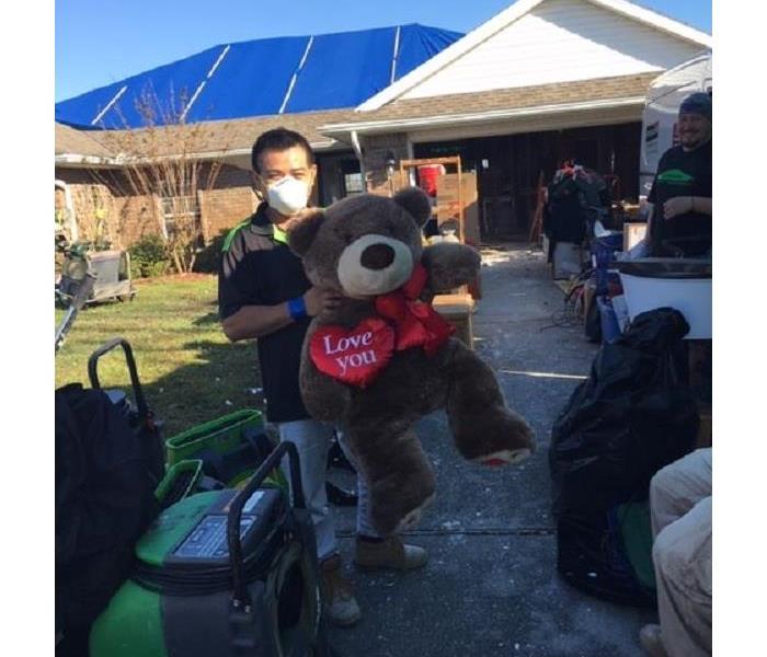 Misael holding stuffed bear